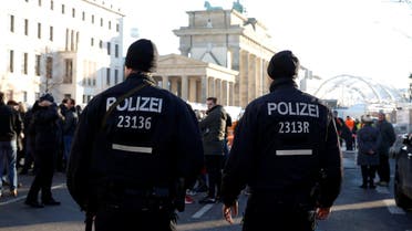 German police men patrol with submachine gun at the Brandenburg Gate, ahead of the upcoming New Year's Eve celebrations in Berlin, Germany, December 30, 2016. REUTERS/