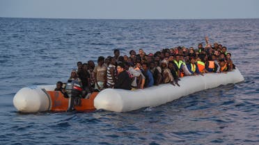 Migrants and refugees sit on a rubber boat before to be rescued by the ship Topaz Responder run by Maltese NGO Moas and Italian Red Cross off the Libyan coast in the Mediterranean Sea, on November 5, 2016 off the coast of Libya. AFP