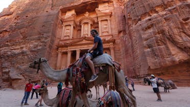 Tourists take pictures in front of the Treasury site during their visit to the ancient city of Petra, south of Amman, Jordan, July 23, 2016. (Reuters)