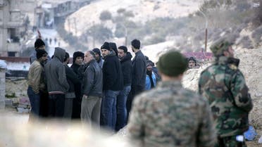 A handout picture released by the official Syrian Arab News Agency (SANA) on January 11, 2017 shows civilians living in the villages of the rebel-held Wadi Barada area of rural Damascus waiting to have their documents checked by government officials before being granted safe passage out of the area. Syria's government has reached a deal for the army to enter a rebel-held area near Damascus and restore the capital's water supply, the provincial governor said. Opposition sources denied there was any such deal, but a source inside the Wadi Barada region reported several hundred civilians were leaving under an agreement. AFP