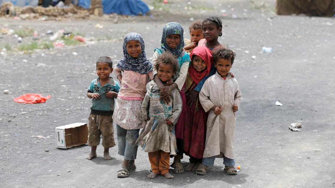 Children pose for a picture at a camp for internally displaced people near Sanaa, Yemen, May 26, 2016. reuters)