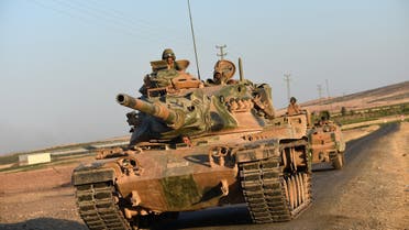 Turkish soldiers stand in a Turkish army tank driving back to Turkey from the Syrian-Turkish border town of Jarabulus on September 2, 2016 in the Turkish-Syrian border town of Karkamis. (AFP)