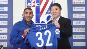 Football player Carlos Tevez holds a team shirt with Wu Xiaohui, Chairman of Shanghai Greenland Shenhua Football Club during a news conference in Shanghai, China, January 21, 2017. REUTERS/Stringer ATTENTION EDITORS - THIS IMAGE WAS PROVIDED BY A THIRD PARTY. EDITORIAL USE ONLY. CHINA OUT. NO COMMERCIAL OR EDITORIAL SALES IN CHINA.
