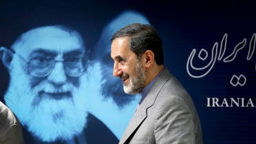Iranian senior foreign policy advisor Ali Akbar Velayati walks past a portrait of supreme leader Ayatollah Ali Khamenei. (File photo: AP)