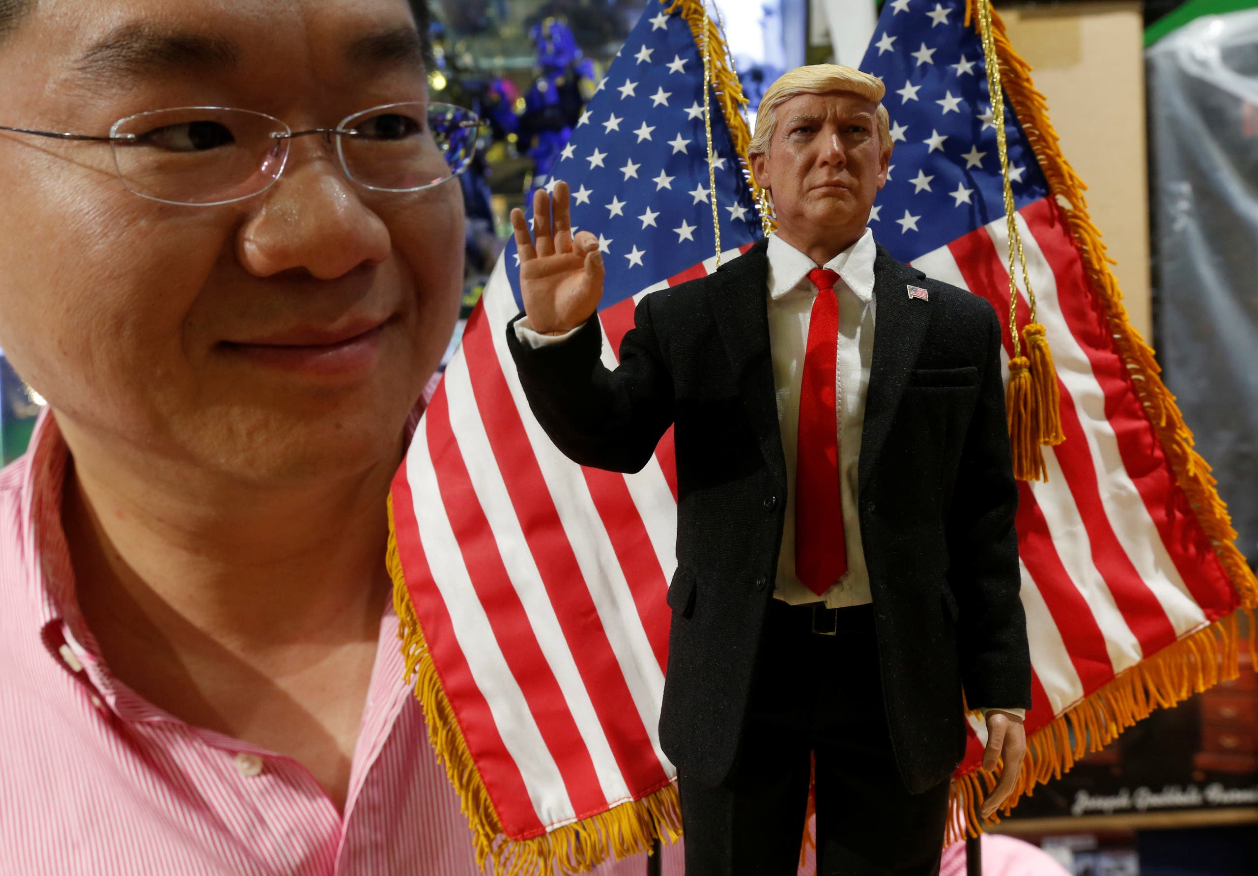 DID Corporation CEO Howard Cheung poses with a prototype 12-inch action figure of U.S. President Donald Trump, which will be available in March, in Hong Kong, China January 21, 2017. REUTERS/Bobby Yip TPX IMAGES OF THE DAY