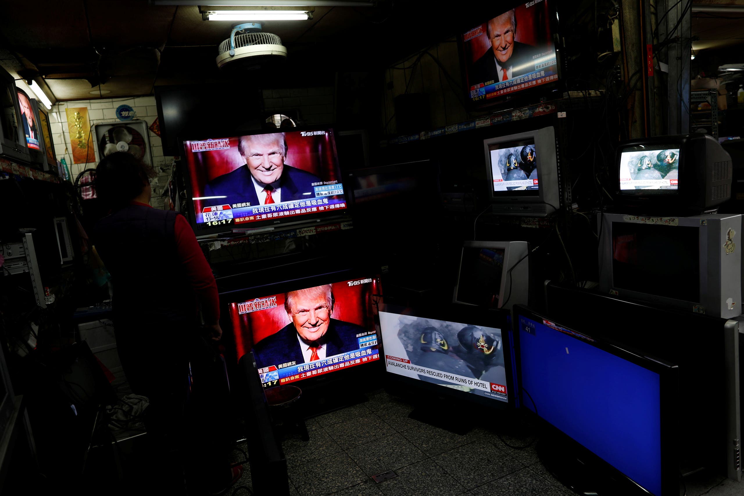 Images of U.S. President Donald Trump are seen on TV screens at a second hand shop in Taipei,Taiwan January 21, 2017. REUTERS/Tyrone Siu