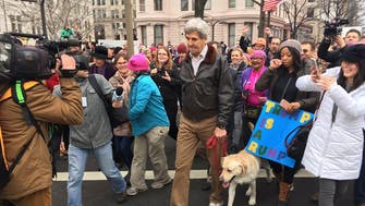 In Pictures: John Kerry shows up at anti-Trump march with his dog