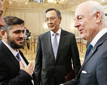 UN envoy for Syria Staffan de Mistura (R) speaks with chief opposition negotiator Mohammad Alloush (L) of the Jaish al-Islam (Army of Islam) rebel group as Kazakh Foreign Minister Kairat Abdrakhmanov stands beside prior to the first session of Syria peace talks at Astana's Rixos President Hotel on January 23, 2017.