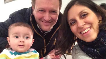 An undated handout image released by the Free Nazanin campaign in London on June 10, 2016 shows Nazanin Zaghari-Ratcliffe (R) posing for a photograph with her husband Richard and daughter Gabriella (L). Richard Ratcliffe told AFP that his wife, aged 37 and holds dual Iranian- British nationality (not recognized in Iran), was arrested on April 3 at Tehran airport as she was preparing to return to the UK with her daughter, then aged 22 months, after a visit to his family in Iran. AFP
