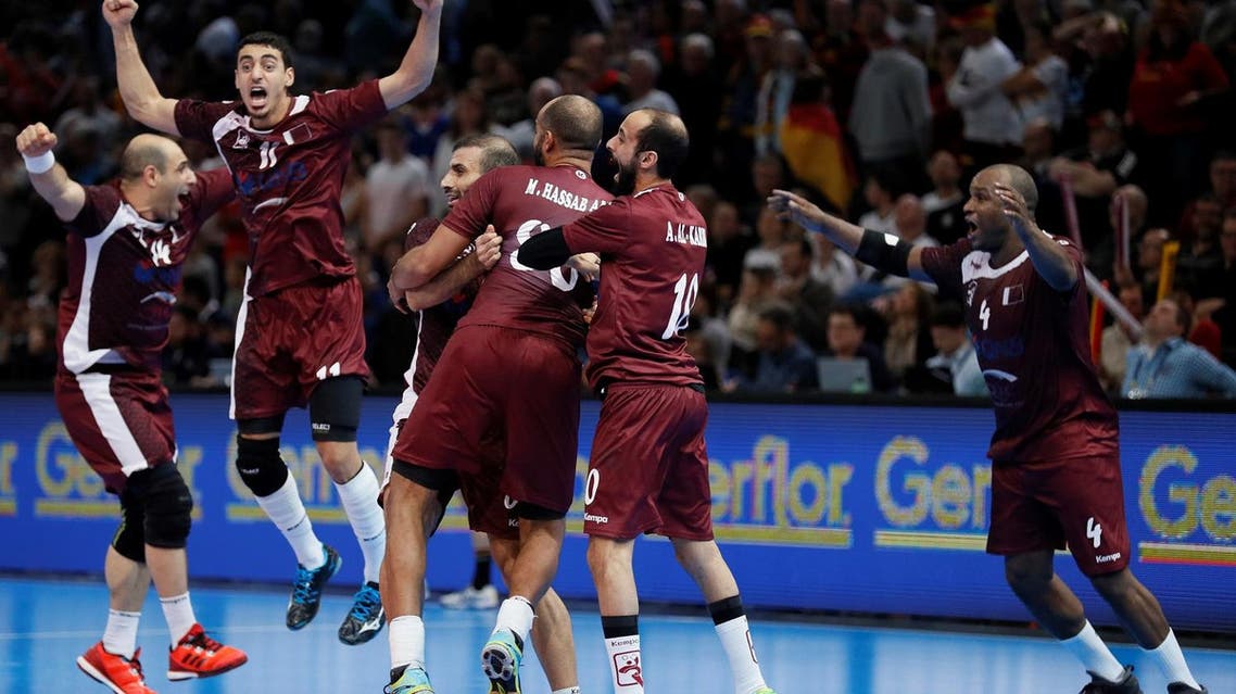 Qatar's pivot Bassel Alrayes (L), Qatar's left wing Murad Abdulrazzaq (2ndL), Qatar's left wing Hassan Mabrouk (R) and teammates celebrate after Qatar defeated Germany in the 25th IHF Men's World Championship 2017 eighth final handball match Germany vs Qatar on January 22, 2017 at the AccorHotels Arena in Paris. THOMAS SAMSON / AFP