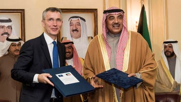 A handout picture released by the NATO Media Library on January 24, 2017 shows Kuwaiti First Deputy Prime Minister and Foreign Minister Sheikh Sabah al-Khaled al-Sabah (R) posing for a picture with NATO Secretary General Jens Stoltenberg following their meeting in Kuwait City. 