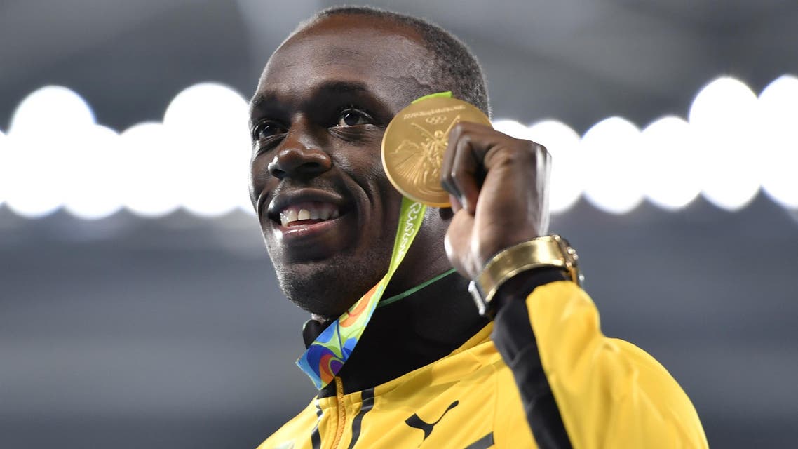 Jamaica's Usain Bolt poses with his gold medal during the podium ceremony for the Men's 200m during the athletics event at the Rio 2016 Olympic Games at the Olympic Stadium in Rio de Janeiro on August 19, 2016. (AFP)