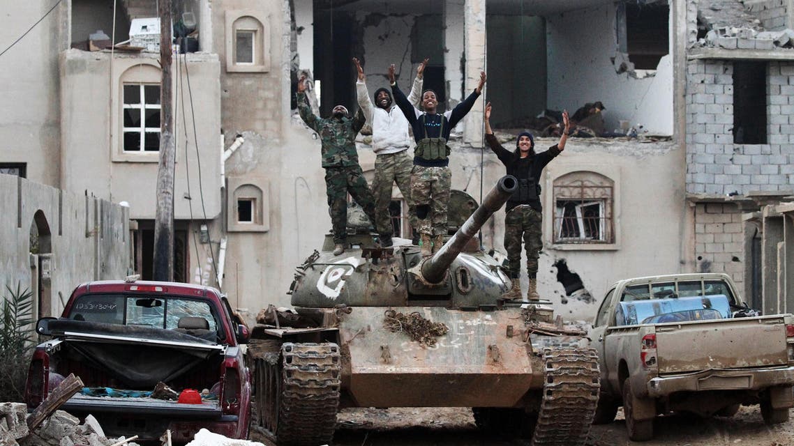 Members of the Libyan National Army (LNA) wave from a tank as they hold a position during fighting against jihadists in Qanfudah, on the southern outskirts of Benghazi, on January 14, 2017