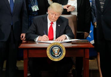 President Donald Trump signs an executive order for border security and immigration enforcement improvements, Wednesday, Jan. 25, 2017, at the Homeland Security Department in Washington. (AP)