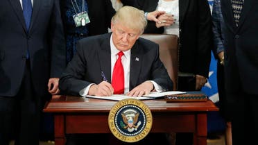 President Donald Trump signs an executive order for border security and immigration enforcement improvements, Wednesday, Jan. 25, 2017, at the Homeland Security Department in Washington. (AP)