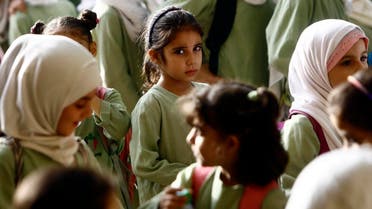 Syrian girls, who fled the ongoing conflict in Syria, stand in line at an all girls school in the south of Khartoum. (AFP)