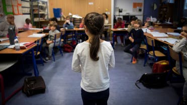 A girl stands as pupils following the Freinet teaching method study in a class room on December 12, 2016 in Paris. AFP