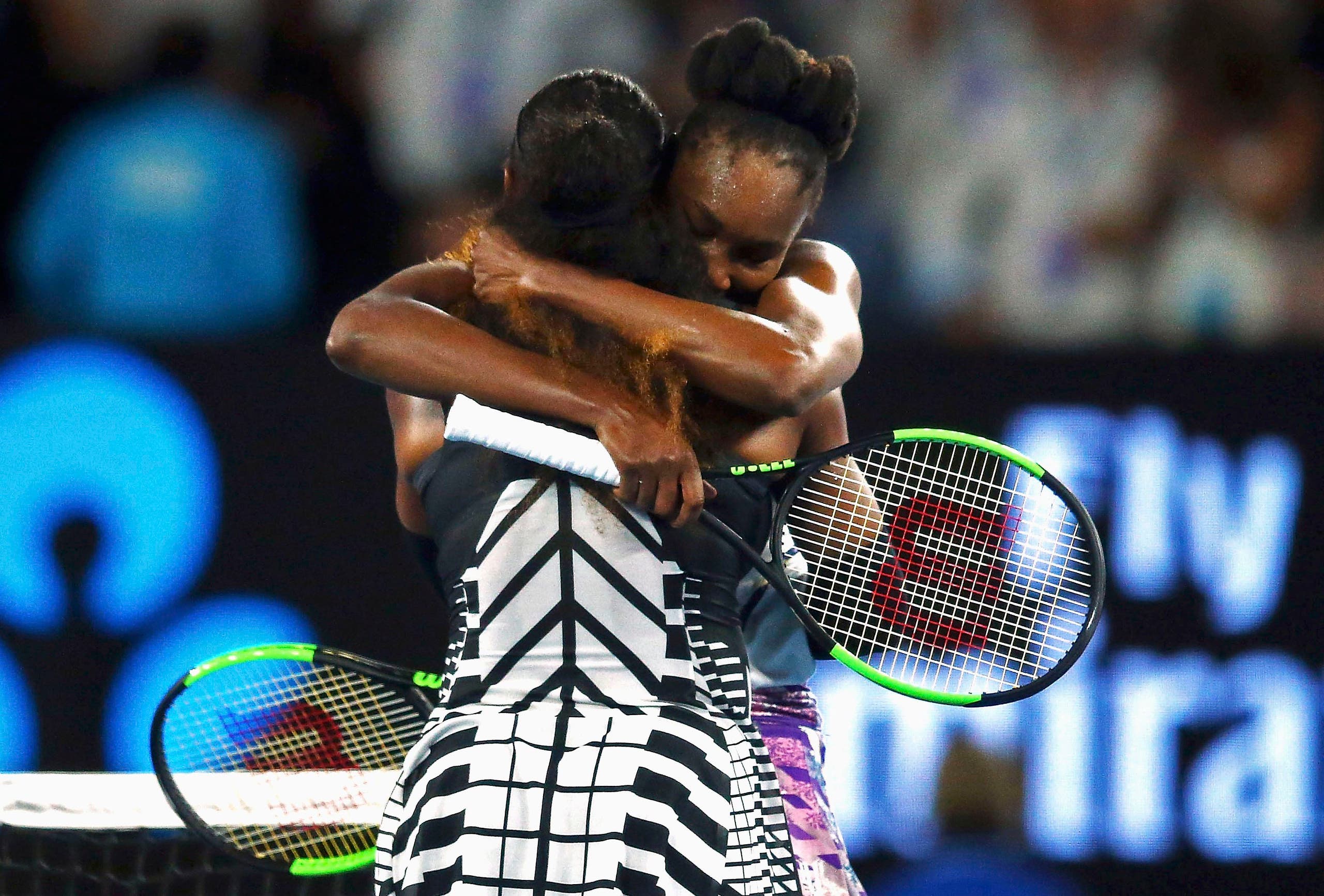 Serena sat on the court, holding both arms up for a while, before Venus walked over to her sister’s side of the net for a hug. (Reuters)