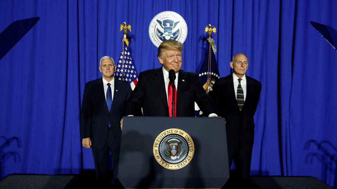 President Donald Trump (C), flanked by Vice President Mike Pence (L) and Homeland Security Secretary John Kelly (R), takes the stage to deliver remarks at Homeland Security headquarters in Washington, U.S. January 25, 2017.