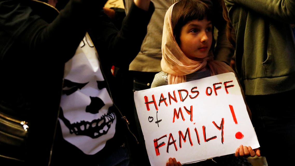 Rosalie Gurna, 9, holds a sign in support of Muslim family members as people protest against U.S. President Donald Trump's travel ban on Muslim majority countries at the International terminal at Los Angeles International Airport (LAX) in Los Angeles, California, U.S., January 28, 2017. REUTERS/Patrick T. Fallon