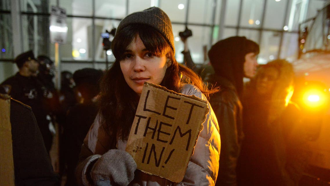 Protestors rally during a demonstration against the new immigration ban issued by President Donald Trump at John F. Kennedy International Airport on January 28, 2017 in New York City