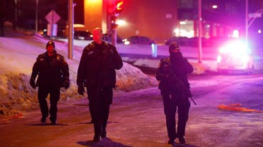Police officers patrol the perimeter near a mosque after a shooting in Quebec City. (Reuters)