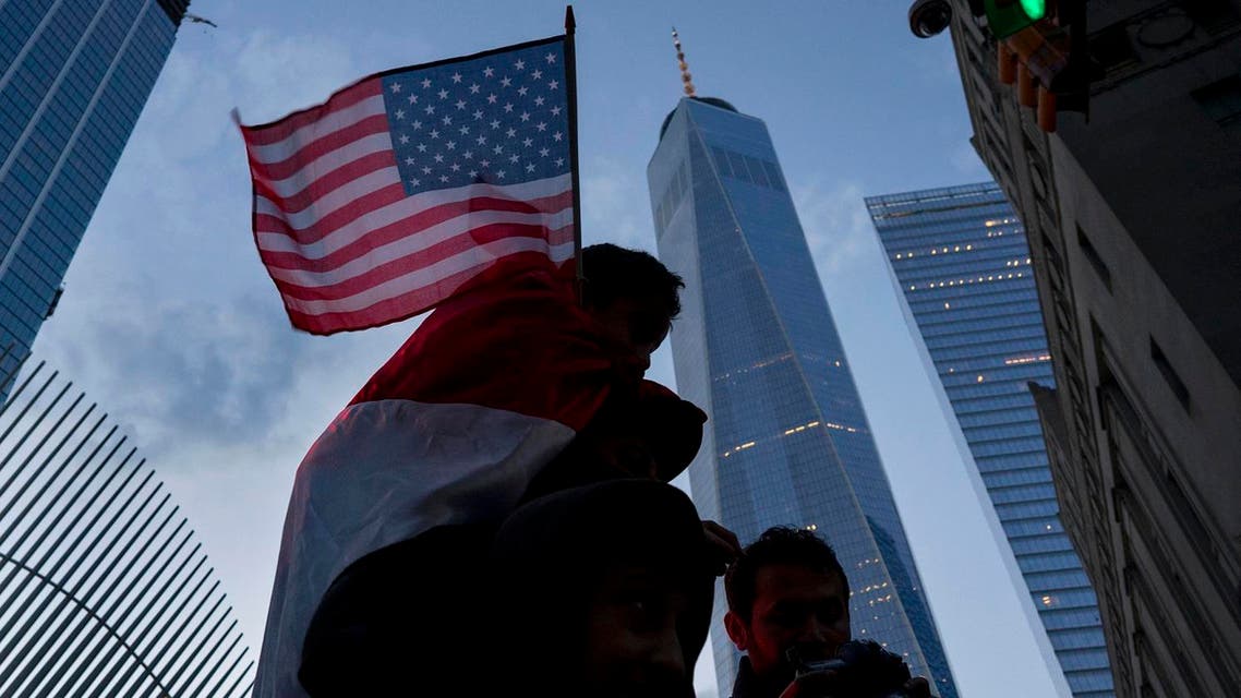 With One World Trade Center in the background, people march in New York, Sunday, Jan. 29, 2017, as they protest against President Donald Trump's executive order banning travel to the US by citizens of several countries. (AP Photo/Craig Ruttle)