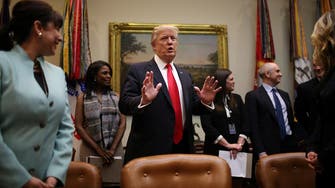 Trump clarifies travel ban policy amid uproar