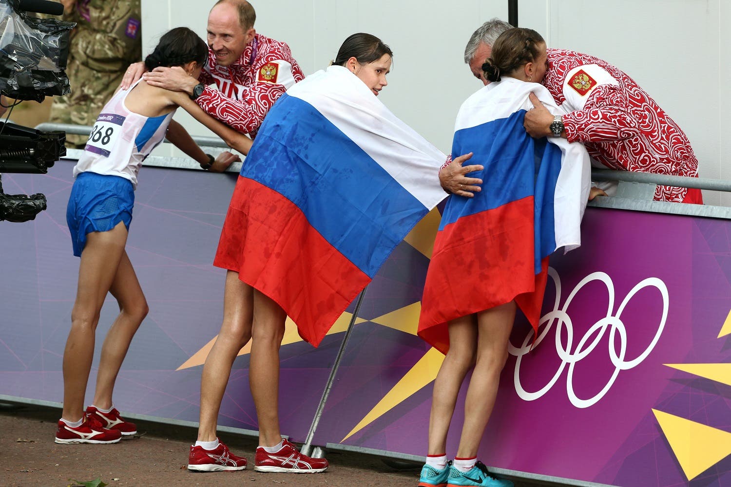  In this Aug. 11, 2012 file photo Russia coach Alexey Melnikov congratulates Olga Kaniskina, right, and Russia men's gold medalist Sergey Kirdyapkin congratulates Anisya Kirdyapkina, left, after the women's 20-kilometers race walk at the 2012 Summer Olympics in London. (AP)