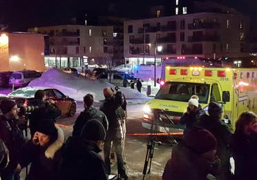 An ambulance is parked at the scene of a fatal shooting at the Quebec Islamic Cultural Centre in Quebec City. (Reuters)