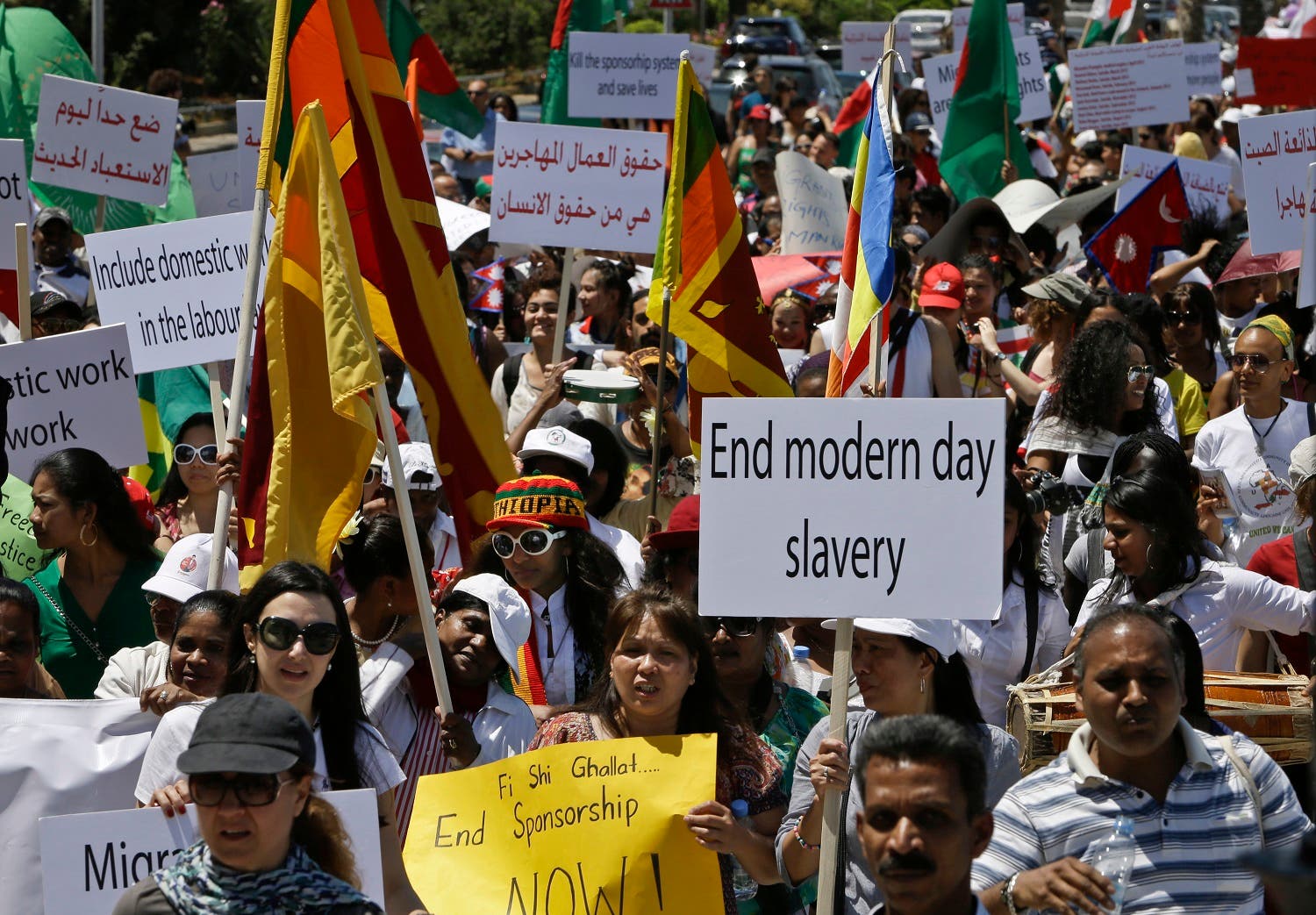 In this Sunday, April 28, 2013 file photo, migrant domestic workers hold posters demanding the same basic labor rights as that of the Lebanese workers during a march in Beirut, Lebanon. (AP)