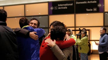 Mazdak Tootkaboni (2nd L) is reunited with friends and family after he was separated from other passengers and questioned as a result of U.S. Donald Trump's executive order travel ban, at Logan Airport in Boston, Massachusetts, U.S. January 28, 2017. Tootkaboni, an Iranian with a U.S. green card, is a professor at the University of Massachusetts Dartmouth (UMASS). REUTERS