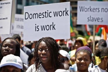 Migrant domestic workers, hold banners demanding basic labor rights as Lebanese workers, during a march at Beirut's seaside, Lebanon, Sunday, April 28, 2013. (AP)