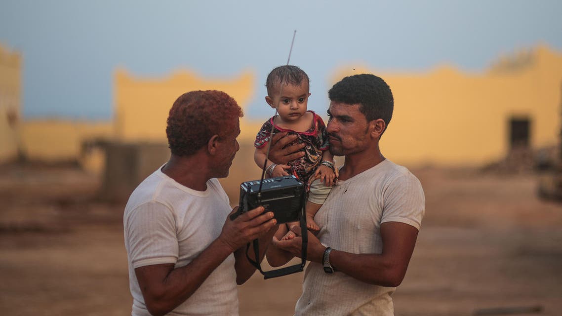 In this Wednesday, May 20, 2015 photo, Yemeni refugees listen to the news on the radio outside their room at an orphanage that has been turned into a center for Yemeni refugees,in Obock, northern Djibouti. AP