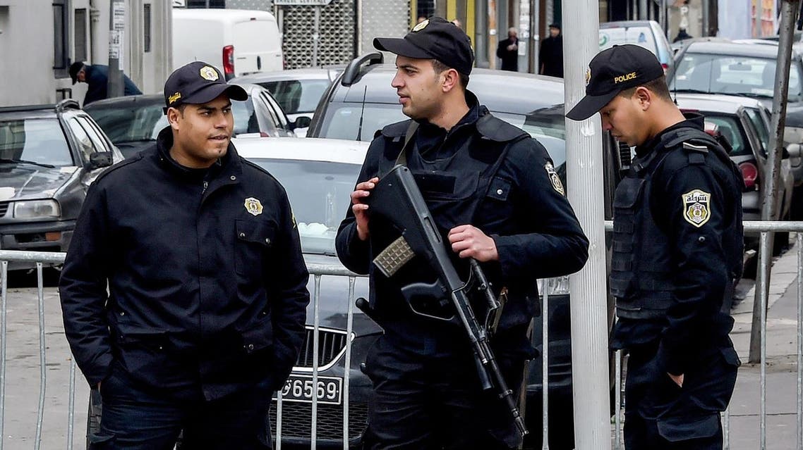 Tunisian police stand guard at a roadblock near a rally on January 14, 2017 in the Habib Bourguiba Avenue in the capital Tunis marking the sixth anniversary of the 2011 revolution. (AFP)
