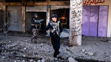 Members of the Iraqi special forces Counter Terrorism Service (CTS) walk next to destroyed shops in eastern Mosul on January 18, 2017. Iraqi forces have fully retaken east Mosul from the Islamic State group, a top commander said, three months after a huge offensive against the jihadist bastion was launched. (AFP)