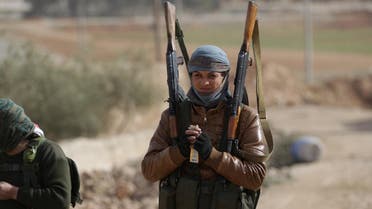 A rebel fighter carries his weapons on the outskirts of the northern Syrian town of al-Bab, Syria January 26, 2017. REUTERS