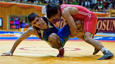 Mehdi Taghavi Kermani of Iran (in red) fights Jabrayil Hasanova of Azerbaijan during their 66kg men's wrestling match at the Tehran Freestyle World Cup competition March 8, 2009. REUTERS