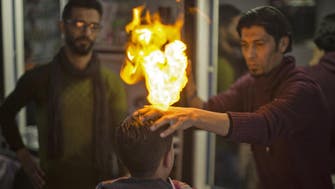 How is this Palestinian barber using fire to style hair? 