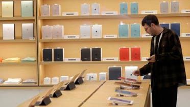 A man looks at iPad tablets displayed at a store on Apple's campus before an announcement of new products Thursday, Oct. 27, 2016, in Cupertino, California. (AP)
