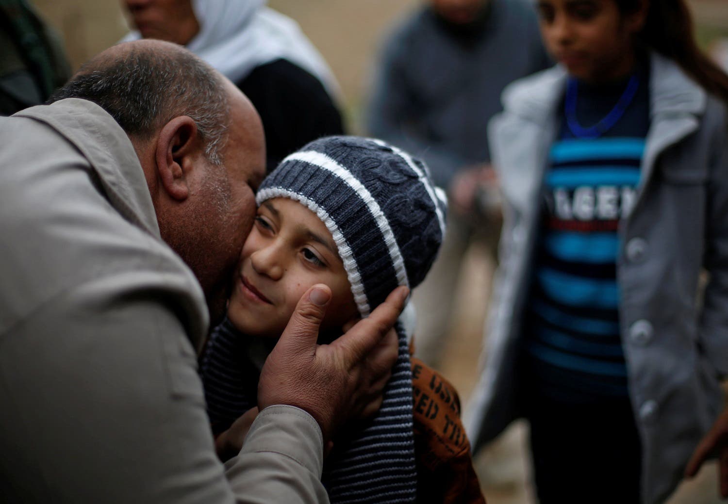 Ayman is greeted by his relative after he was returned to his Yazidi family in Duhok, Iraq. (Reuters)