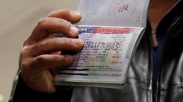 A member of the Al Murisi family, Yemeni nationals who were denied entry into the U.S. last week because of the recent travel ban, shows the cancelled visa in their passport. (Reuters)