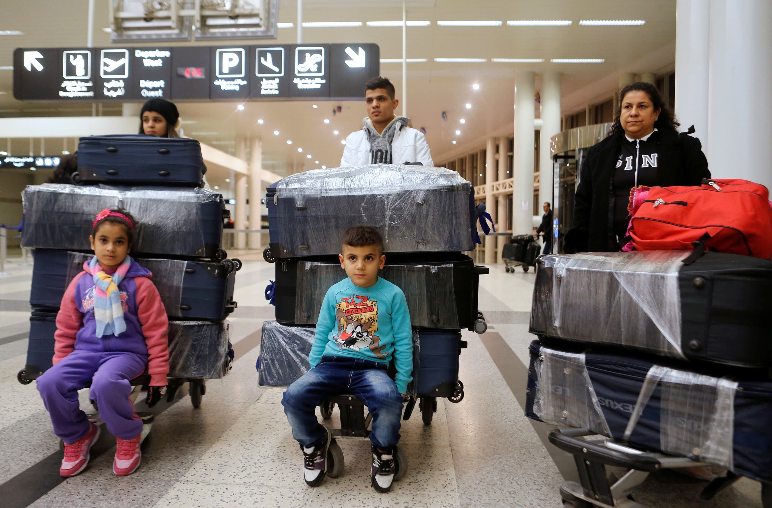 The al-Qassab family, Iraqi Christian refugees from Mosul, pose with their luggage at Beirut international airport ahead of their travel to the United States, Lebanon February 8, 2017. (Reuters/Mohamed Azakir)