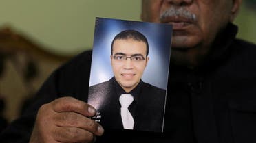 Reda Abdullah al-Hamamy, the father of Abdullah Reda al-Hamamy who is suspected of attacking a soldier in Paris' Louvre museum, holds a picture of his son during an interview with Reuters in Daqahliya, Egypt, February 4, 2017. 