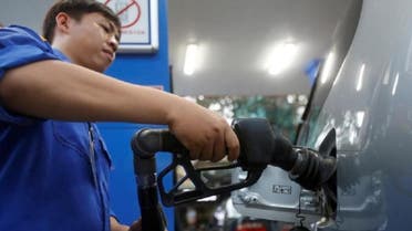 An employee pumps petrol into a car at a petrol station in Hanoi, Vietnam December 20, 2016. REUTERS