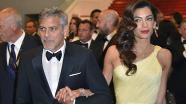 George Clooney and Amal Clooney leave on May 12, 2016 the Festival Palace after the screening of the film “Money Monster” at the 69th Cannes Film Festival in Cannes, southern France. (AFP)