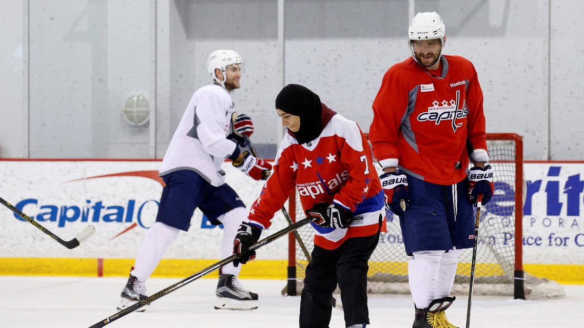 Washington Capitals hockey star Alex Ovechkin smiles as Fatima Al Ali from United Arab Emirates skates with the team in Arlington, Virginia, U.S. February 8, 2017.AFP
