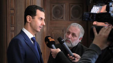 A handout picture released by the official Syrian Arab News Agency (SANA) on February 7, 2017 shows Syrian President Bashar al-Assad (L) giving an interview to a Belgian media outlet. 