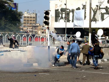 Protesters run from tear gas fired by security forces after Sadr supporters tried to approach the heavily fortified Green Zone during a protest at Tahrir Square in Baghdad. (Reuters)