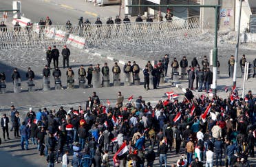 Iraqi security forces stand guard as supporters of the Sadrist movement gather during a demonstration in Baghdad. (AFP)